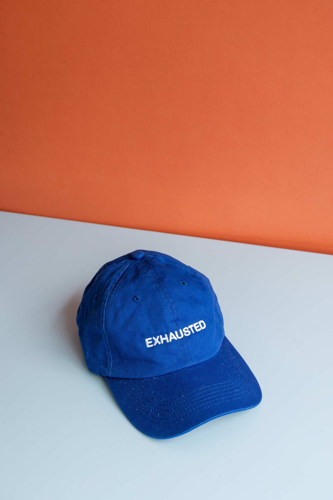 Exhausted Cap (White on Cobalt Blue) by Intentionally Blank